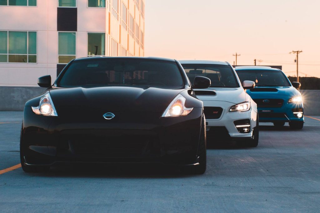 three cars parked at sunset