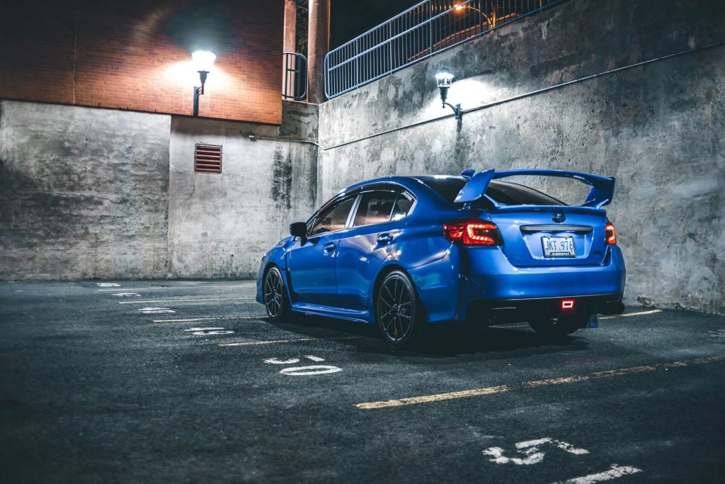 blue sports car parked at night