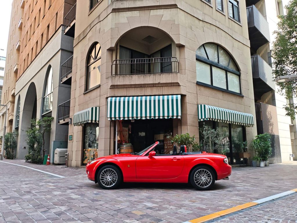 red convertible car parked curbside