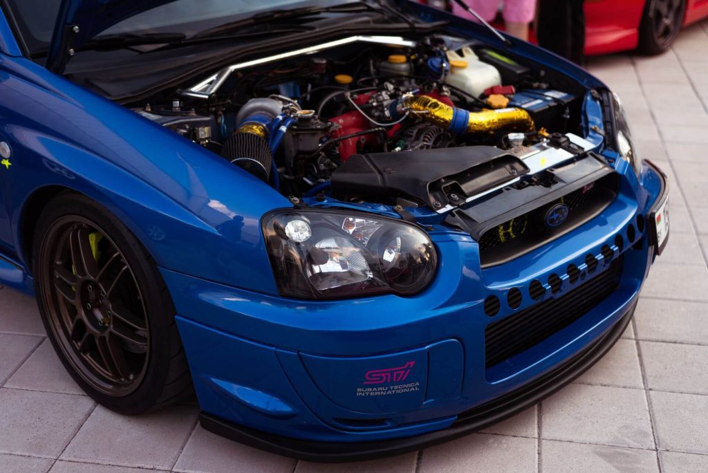 blue subaru car open hood